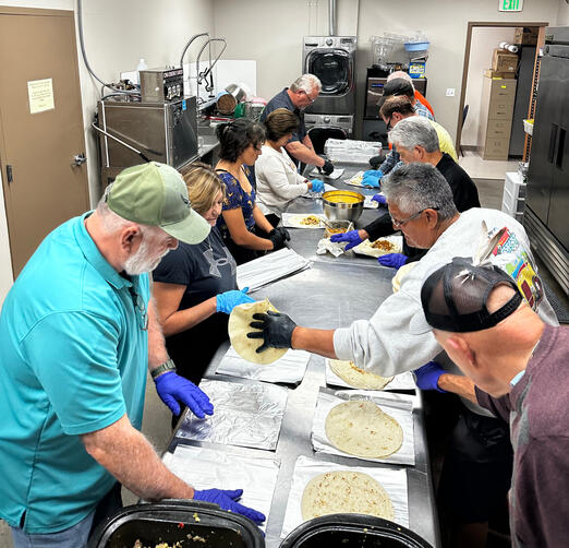Volunteers at burrito making fund raiser